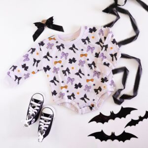 Halloween-themed baby outfit with bats and bows.