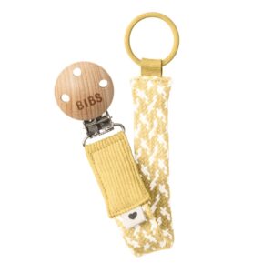 Mustard yellow pacifier holder with clip and loop.