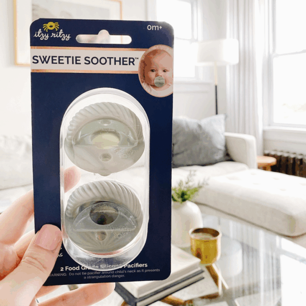 itzy ritzy sweetie soother™ pacifier sets (2 pack): agave + succulent cables Sweetie Soother pacifiers packaging in living room.