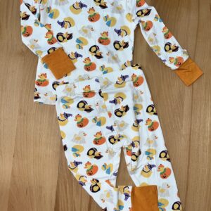 Halloween-themed children's pajamas with pumpkin and duck prints.