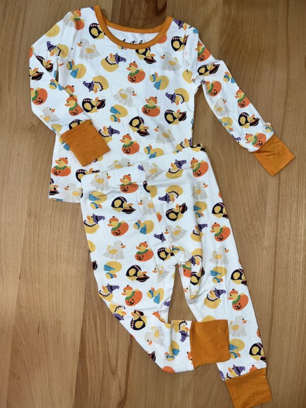Halloween-themed children's pajamas with pumpkin and duck prints.