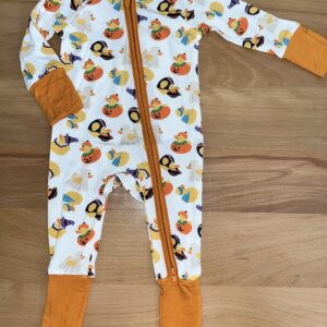 Baby pajamas with duck and pumpkin pattern.