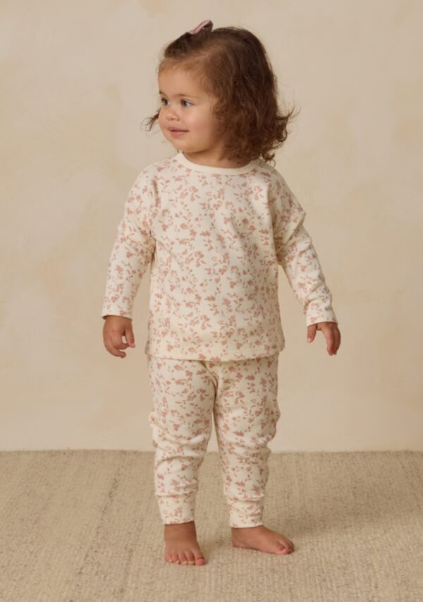 quincy mae sweat set french garden Toddler in floral pajamas standing on carpet