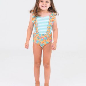 Child wearing floral one-piece swimsuit, smiling.