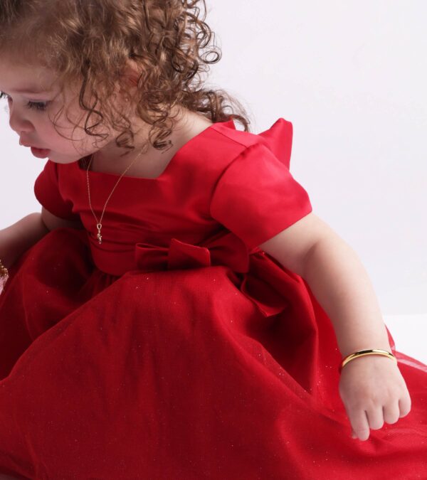 cherished moments gold classic bangle for baby & kids Child in red dress with curly hair.