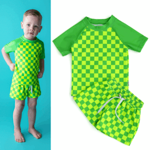 Child wearing green checkered shirt and shorts set.