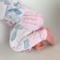 Baby in pink patterned pajama crawling