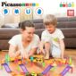 Mother and child playing with colorful building tiles.