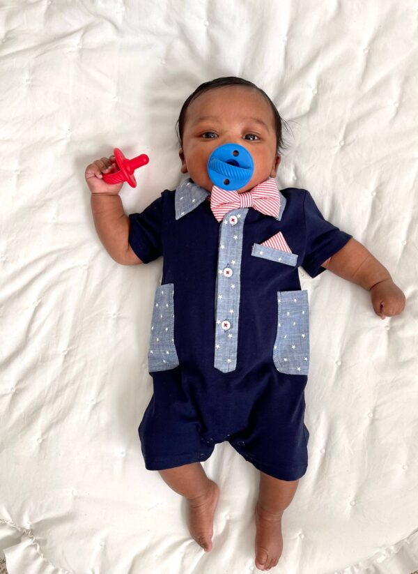 itzy ritzy sweetie soother™ pacifier sets (2 pack): agave + succulent cables Baby with pacifier and bow tie on blanket.