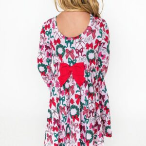 Girl in festive dress with bow and wreath print