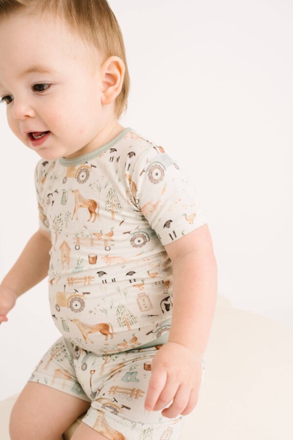 little one shop little farm bamboo shorts set Toddler in farm-themed pajamas on white background.