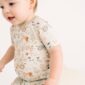 Toddler in farm-themed pajamas on white background.