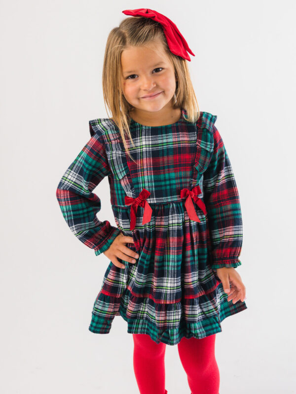 rufflebutts woven long sleeve waterfall bow dress christopher plaid Girl in plaid dress with red bow smiling
