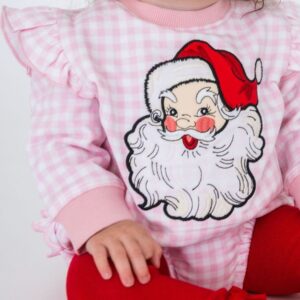 Child in Santa sweater and red leggings.
