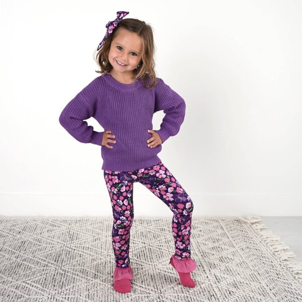 gigi and max mila leggings and sweater set Child in purple sweater and floral leggings smiling.