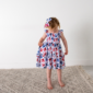 Child wearing floral summer dress indoors
