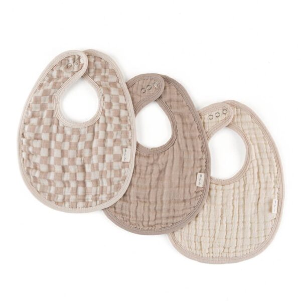 itzy ritzy *new* itzy bibs™: check yes! Three beige baby bibs arranged overlapping on white background.