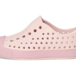 Pink slip-on shoe with ventilation holes.