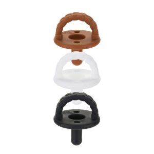 Three pacifiers in brown, white, black.