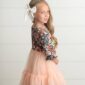 Young girl in floral dress, white bow hair