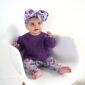 Baby in purple sweater with floral headband