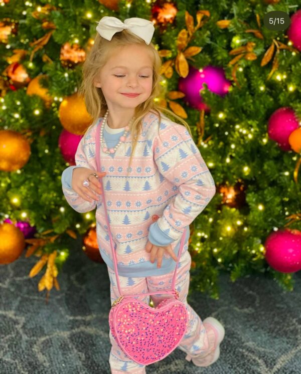 bits & bows sparkle heart purse Child posing by festive Christmas tree with purse.