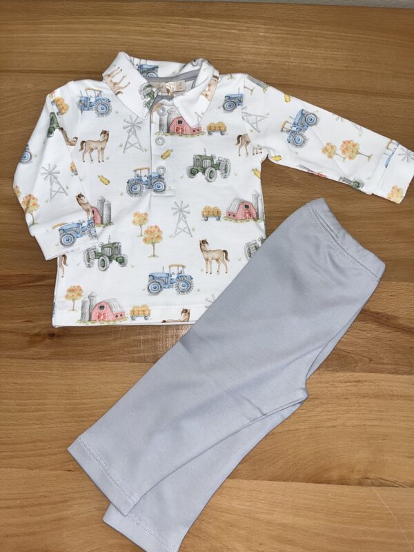 Children's farm-themed pajama set on wooden surface.