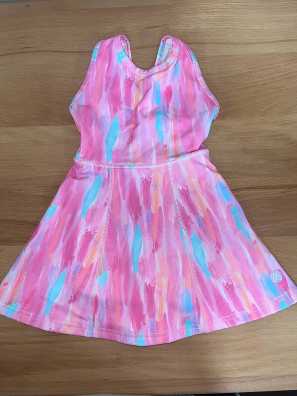 yoga baby spring tye dye open back dress Colorful pink toddler dress on wooden surface.
