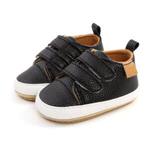 Black baby sneakers with velcro straps.
