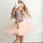Girl spinning in floral top and tutu skirt.