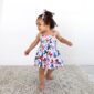 Toddler wearing floral dress and matching headband.