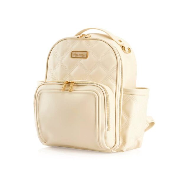 itzy ritzy milk & honey itzy mini plus™ diaper bag backpack Beige quilted backpack with gold accents