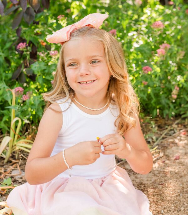 cherished moments girls 14k gold plated pearl necklace children's kids jewelry Smiling child with bow in sunny garden