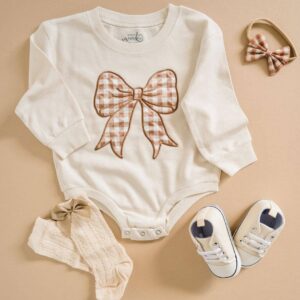 Baby outfit with bow, socks, shoes, and headband.