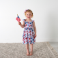Child in patriotic dress holding American flag