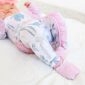 Baby in bow-patterned pajamas with pastel colors.