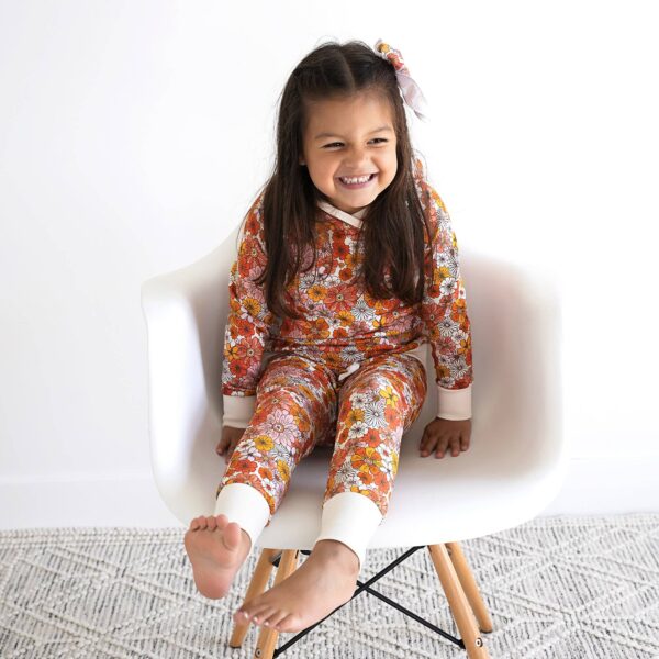gigi and max louisa hoodie set Smiling child in floral pajamas on chair
