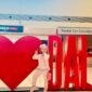 Child posing by DAL airport sign.