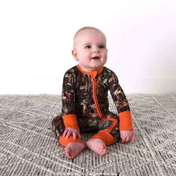 gigi and max hunter camo zip sleepies little bamboo baby outfit Baby wearing camo onesie on carpet.