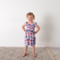 Smiling girl wearing patterned dress and matching headband.