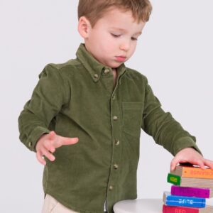 Child stacking colorful books on white table