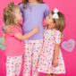 Three girls in colorful heart pajamas smiling