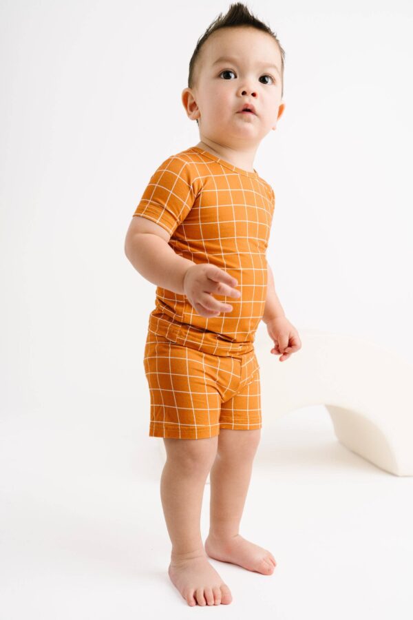 little one shop rust checks bamboo shorts set Toddler in orange grid-patterned outfit.