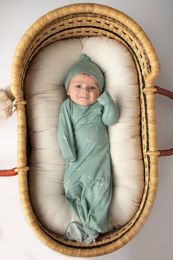 three little tots arrow print knotted newborn baby gown pajamas Baby in green outfit lying in basket