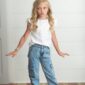 Child posing in casual clothes indoors.