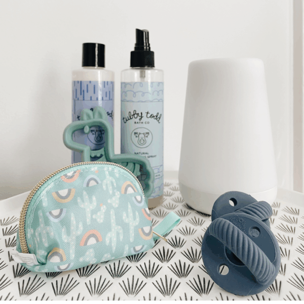 itzy ritzy sweetie soother™ pacifier sets (2 pack): agave + succulent cables Baby bath products with a pacifier and bag.