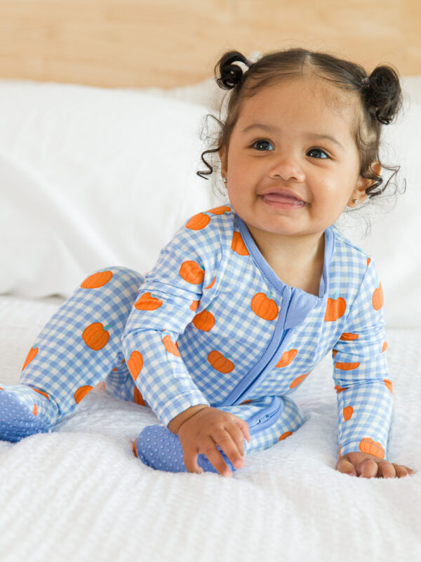 rufflebutts pumpkin patch gingham pajamas Baby in pumpkin pajamas crawling on bed