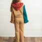 Child with colorful outfit, facing away.