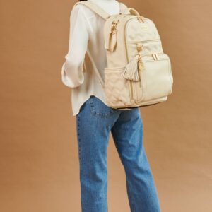 Woman smiling, wearing beige backpack, jeans outfit.