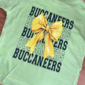 Green shirt, yellow bow, Buccaneers text design.